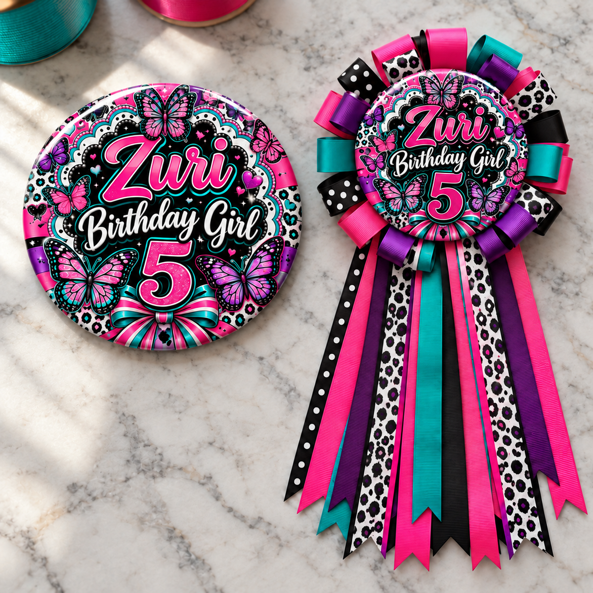 butterfly themed personalized birthday button and ribbon mum displayed on a marble tabletop